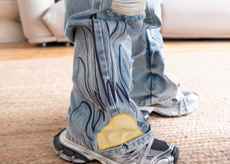 Close-up of sunflower appliqué on Christi Alonzo washed denim